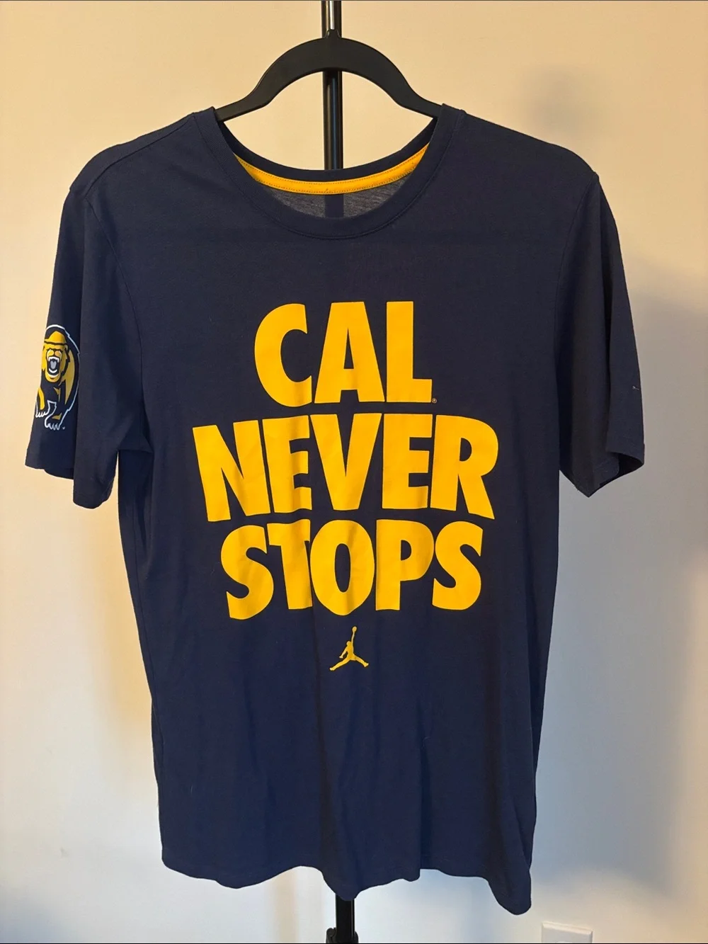 Jordan Navy Blue and Gold 'CAL NEVER STOPS' Short Sleeve Tee